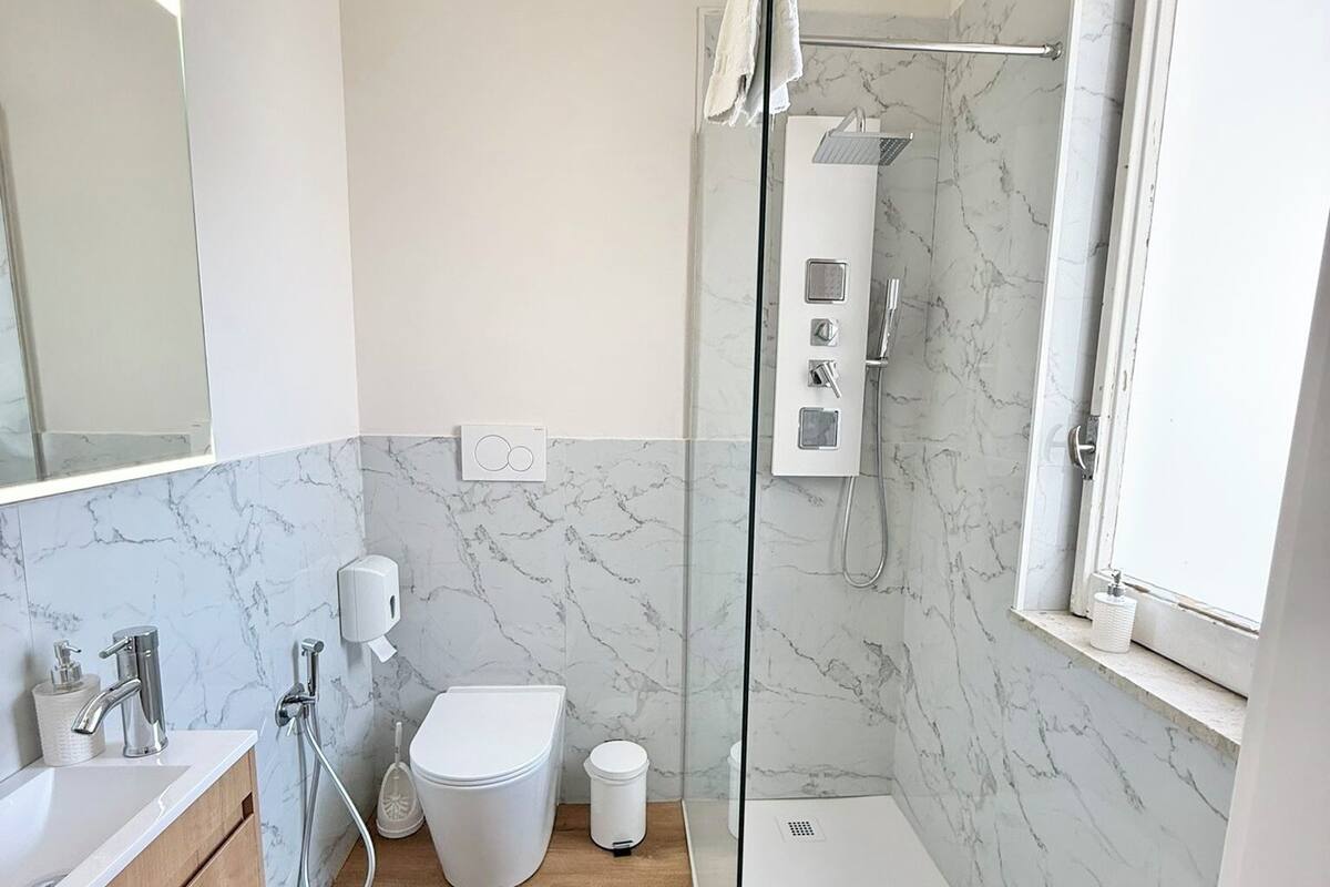 Un baño moderno con ducha, inodoro y lavamanos.