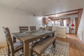 Cozy living space with a central dining table and kitchenette area.