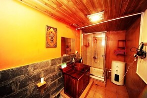 A bathroom with a wooden ceiling, a shower, a sink, and a toilet. - Old Yard Inn (Shangri-La)