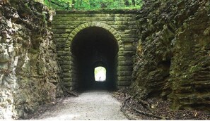 Walk through the arched entrance to a brighter area beyond.