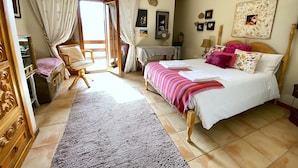 A bedroom with a bed, a chair, a desk, and a window with curtains. - Stunning Country Side House with swimming pool (Penafiel)