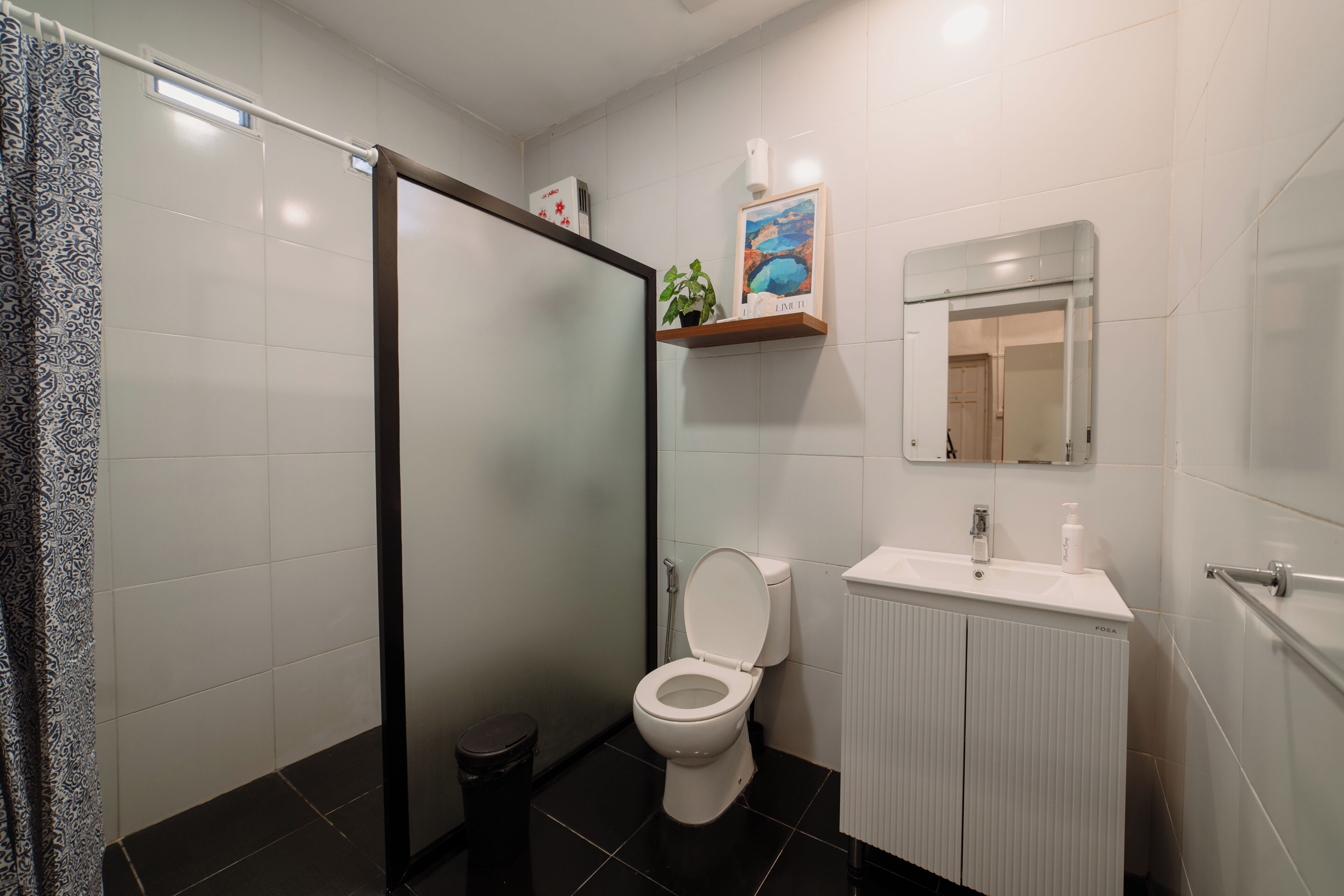 A modern bathroom with a toilet, sink, and shower area.