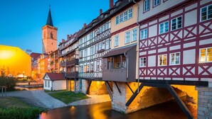 A traditional European town with a river, a bridge, and a church tower. - Apartment 'Ferienwohnung Beyer Friedrichroda' with Private Terrace, Private Garden and Wi-Fi (Friedrichroda)