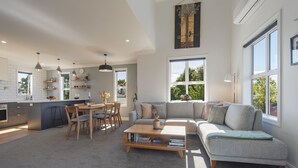 A modern living space with a kitchen, dining area, and a large window providing natural light.