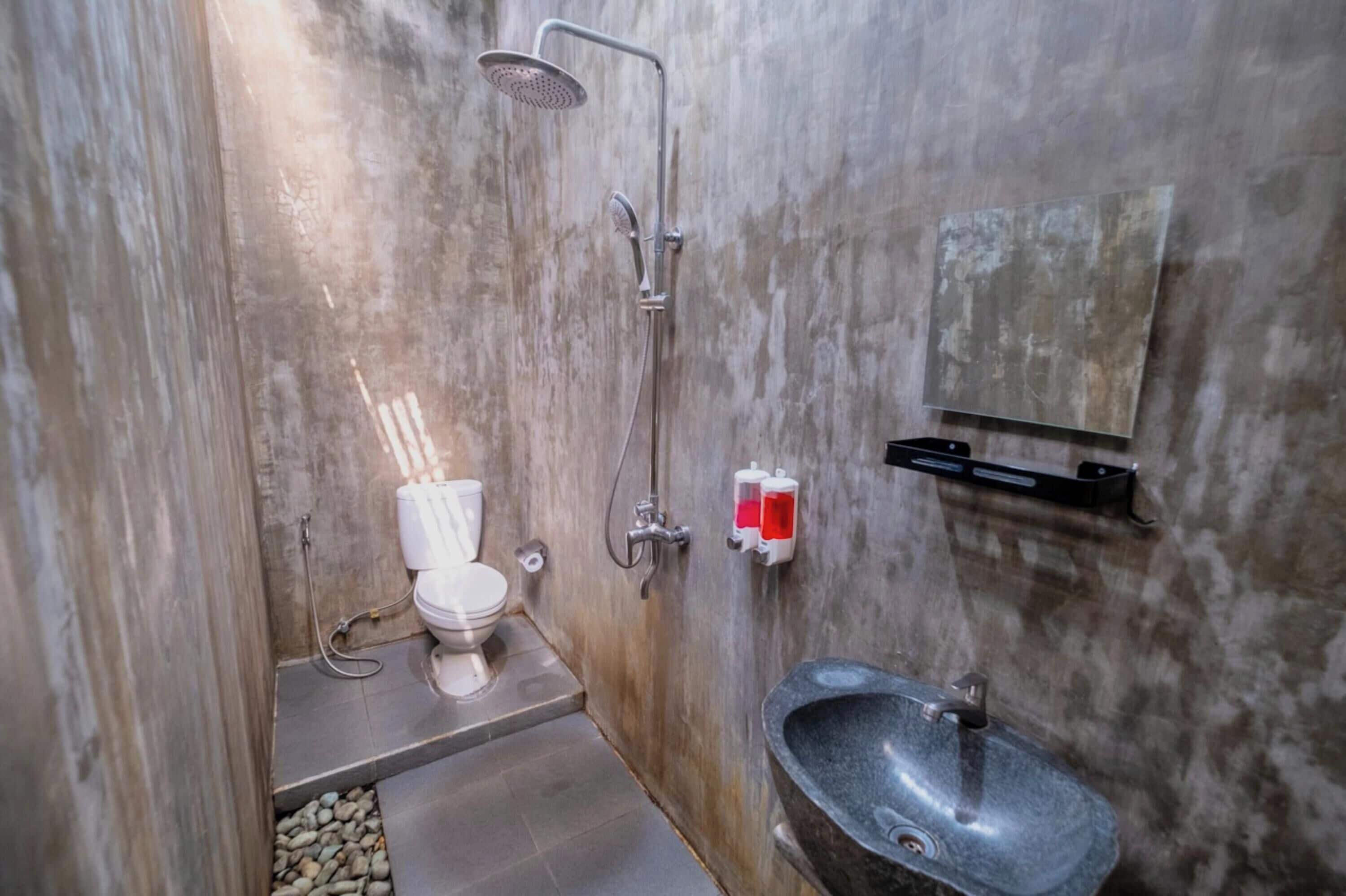 A bathroom with a shower, toilet, and sink.