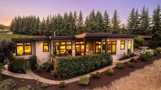 A modern two-story house with large windows, a covered patio, and a well-maintained garden. - Magnificent Panoramic Valley and Vineyard Views, Single Level Two Guest Suite Layout, Amazing Deck (Dundee)