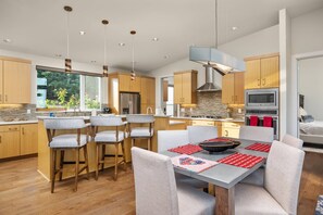 A modern kitchen with wooden cabinets, a stainless steel refrigerator, and a built-in oven. - Magnificent Panoramic Valley and Vineyard Views, Single Level Two Guest Suite Layout, Amazing Deck (Dundee)