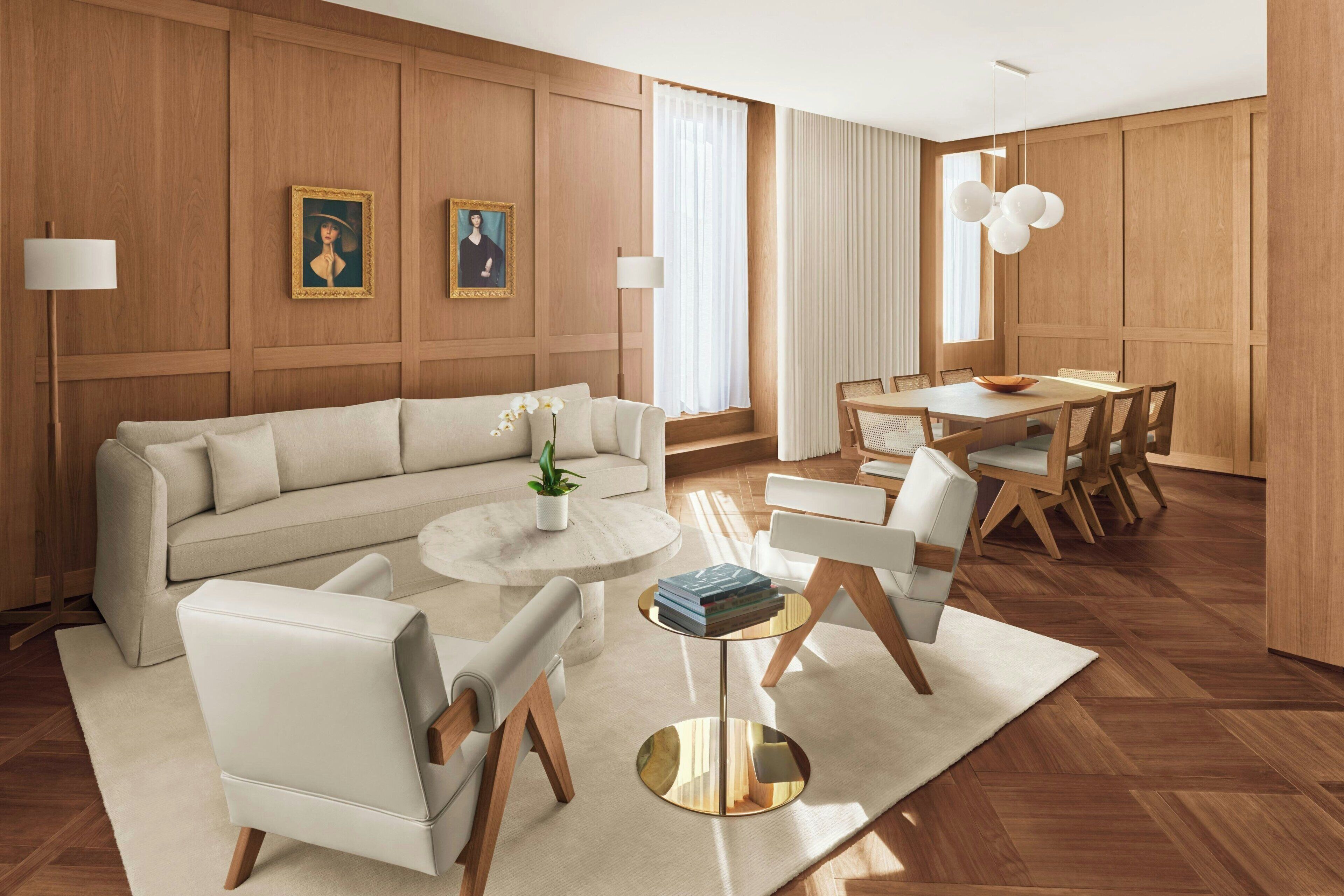 A modern living room with a sofa, chairs, a coffee table, and a dining area with a table and chairs.