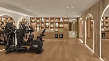 A gym with exercise equipment and neatly organized shelves of toiletries.