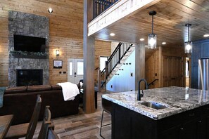 Cozy living area with a fireplace, flat-screen TV, and comfortable seating.
