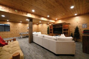 Relax in this inviting room with a comfortable sofa, flat-screen TV, and small table.