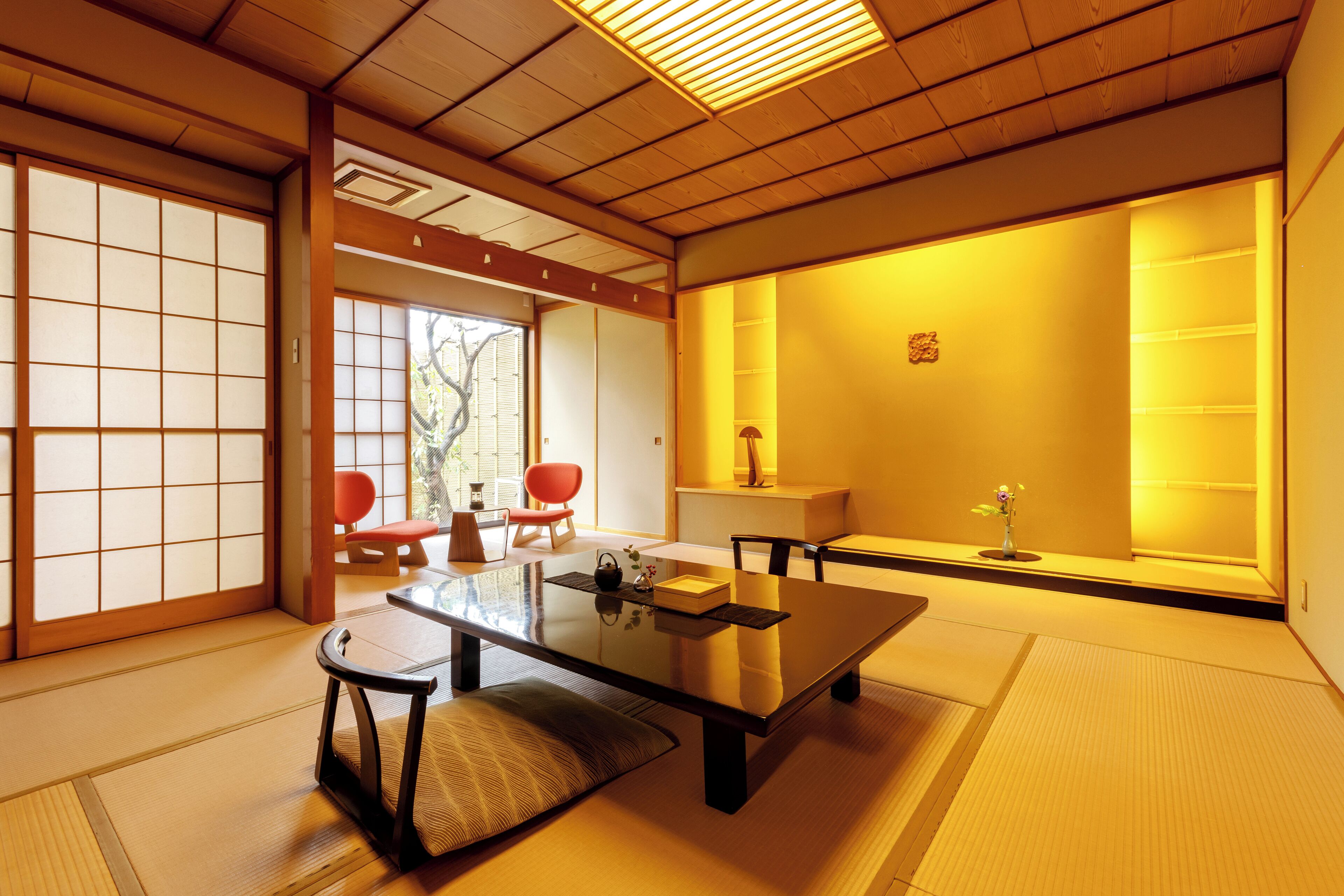 A traditional Japanese room with tatami flooring, a low table, and sliding doors.