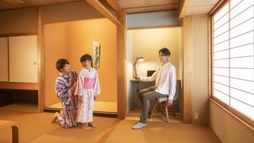 A traditional Japanese room with tatami flooring, a low table, and a sliding door.
