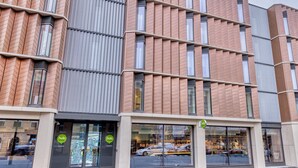 A modern building with a brick facade, large windows, and a storefront with a 'hub' sign. - Hub By Premier Inn London Clerkenwell (London)