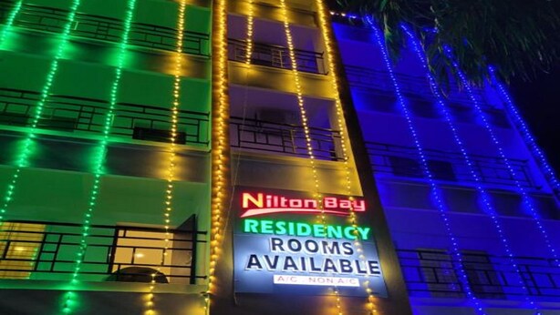 A building with a sign advertising 'Nilon Bay Residency Rooms Available'. - Nilton Bay Residency (Tindivanam)