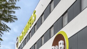 A B&B hotel with a modern facade, large windows, and a visible parking area. - B&B Hotel Lisboa Oeiras  (Oeiras)