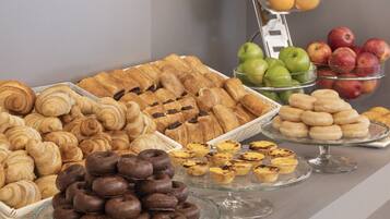 A variety of pastries and fruits on display.