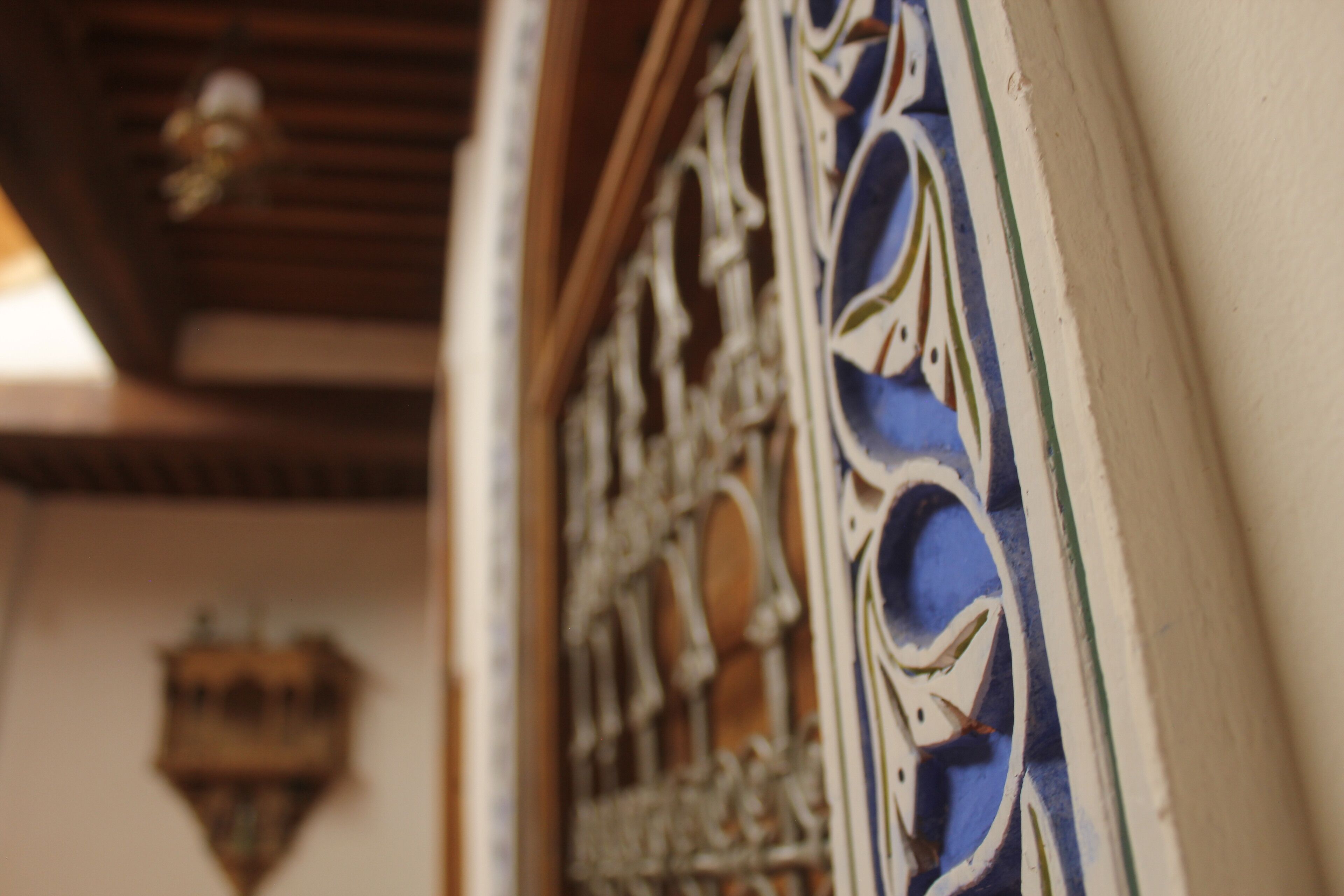 A close-up of a decorative metal gate with intricate designs.