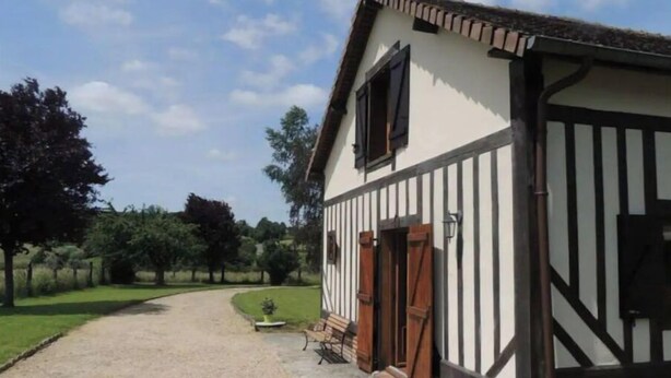 A traditional half-timbered building with a gravel driveway leading to a gated entrance. - Country house in the heart of rural Pays d'Auge (Le Renouard)