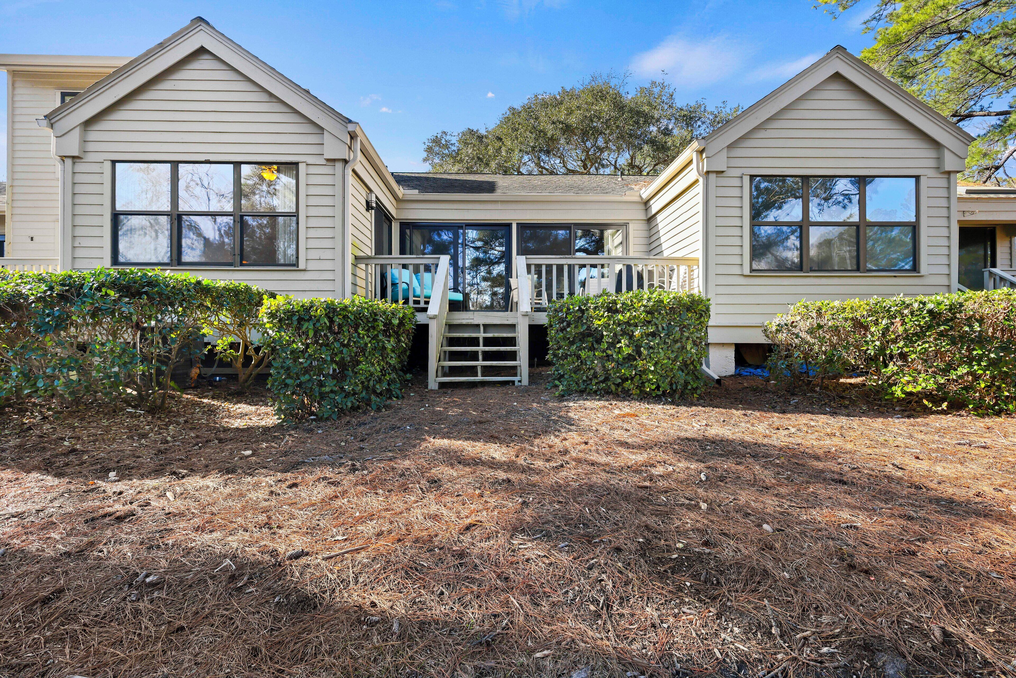 A two-story house with a front deck and a covered entryway.