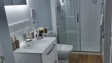 Shower, hair dryer, slippers, towels