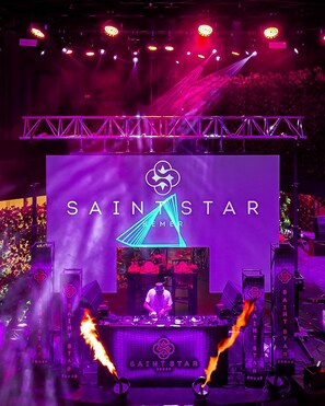 A stage with the text "SAINTSTAR" and a DJ setup.