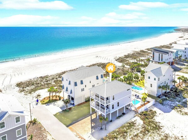 A beachfront property with multiple buildings, a pool, and a beach view. - Watercolor-Mexico Beach! Gulf-Side Home! (Mexico Beach)
