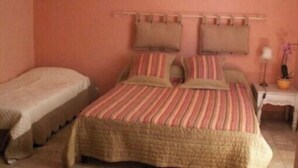 A bedroom with a single bed, a bedside table, and a nightstand. - Gîte le plane tree (Aubignan)