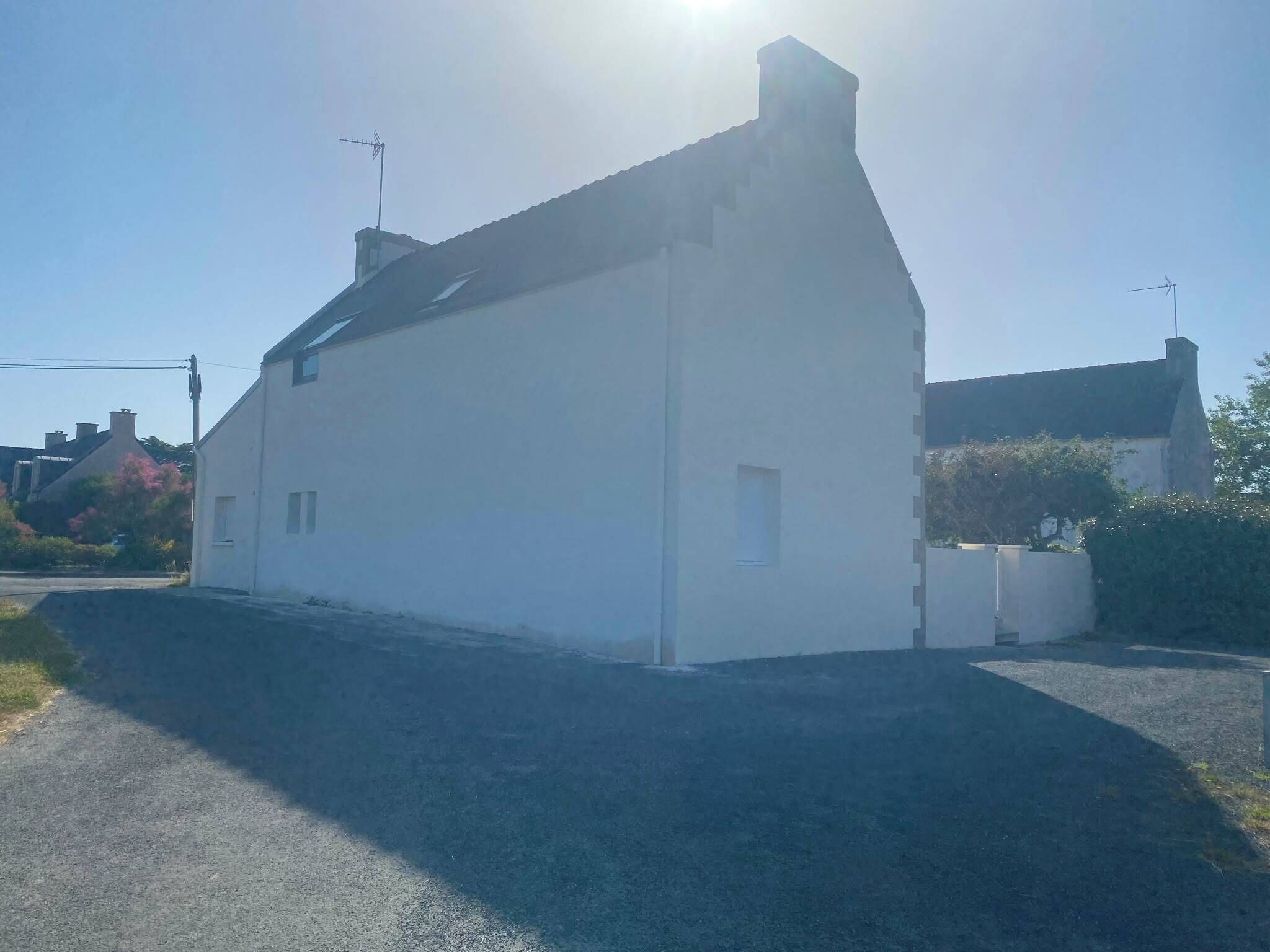A single-story building with a sloped roof, a small window, and a chimney.