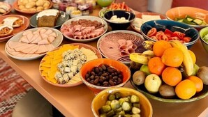 A buffet table with various food items including meats, cheeses, and fruits. -  WorkNomads LAB Hotel-Coliving & Coworking (Sofia)