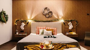 A cozy bedroom with a bed, bedside tables, and a nightstand.