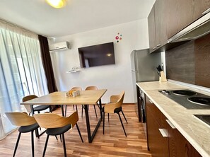 Fridge, electric kettle, cookware/dishes/utensils, dining tables