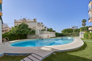 A swimming pool with a surrounding deck, a staircase leading to a building, and a clear blue sky. - Holiday Apartment "Albaida 3j" near Beach with Shared Pool & Wi-Fi (Nerja)