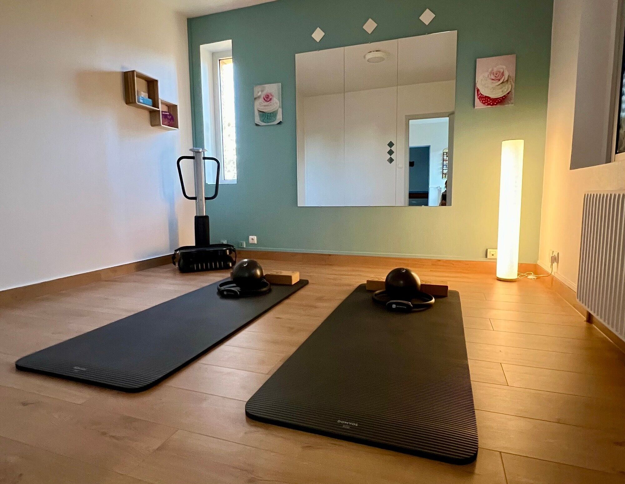 A room with two exercise mats, a stationary bike, and a massage chair.