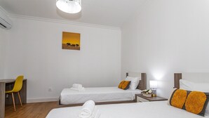 A hotel room with two beds, a desk, and a chair. - Apartment "Oásis Fonte Grande 4" with Sea View, Terrace & Wi-Fi (Santo António)