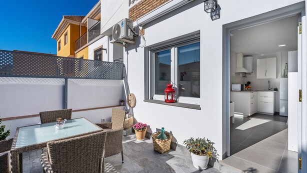 Un apartamento moderno con balcón, comedor y cocina.