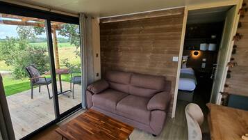 A modern interior with a wooden wall, a sofa, and a table.