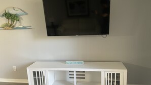 A white entertainment center with a flat-screen TV mounted above it. - -Near Disney-  condo in gated Bahama Bay Resort (Davenport)