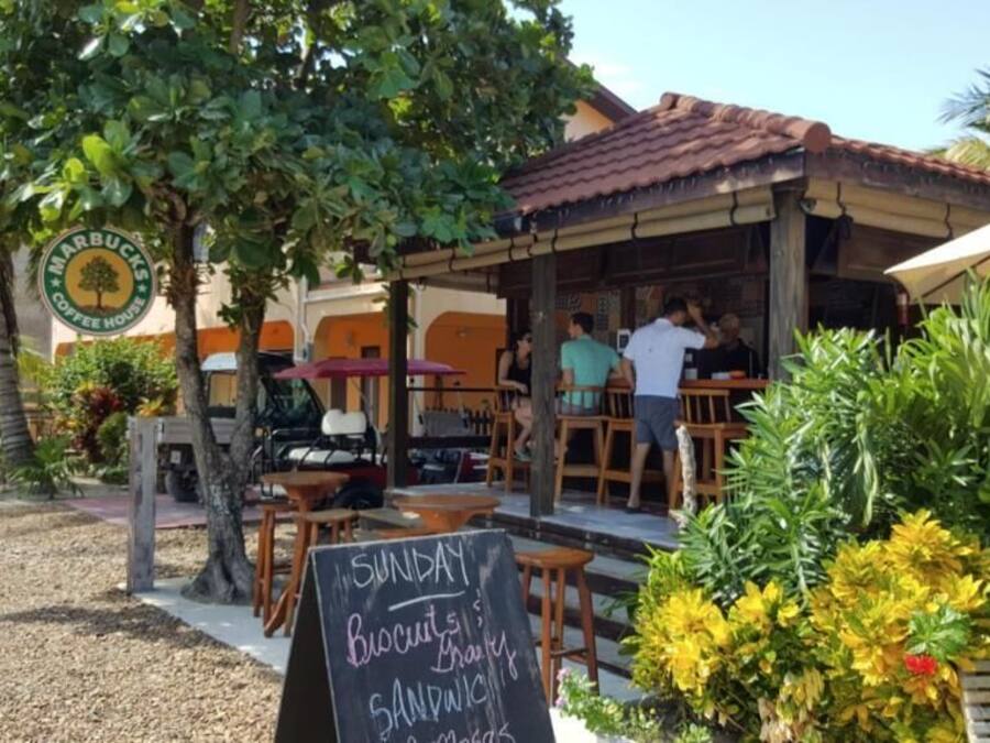 An outdoor seating area with a sign indicating a Sunday brunch menu.