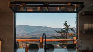 A kitchen with a view of mountains. - 3 Pines Lodges: Luxury, Mountain View, & Hot Tub! (Sevierville)