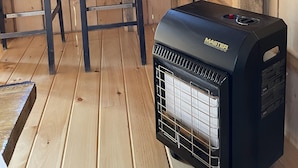 A kitchen with wooden walls, a Coleman kettle, and a Master portable heater. - STARWOOD - PET FRIENDLY! - OFF GRID - ROMANTIC - ON WINE TRAIL (Hammondsport)