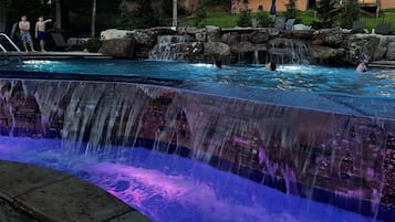 Seasonal outdoor pool, open 10:00 AM to 10:00 PM, pool umbrellas