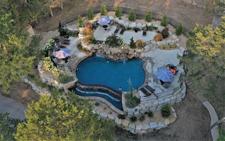 Una piscina al aire libre de temporada, sombrillas