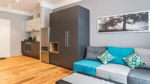 Un salon moderne avec un canapé gris, des coussins turquoise et une table basse.