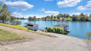 A lakeside property with a dock, a small shed, and a gazebo. - Family Lake Retreat w/ Screened Deck! (Moneta)
