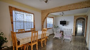 Enjoy meals in this dining area with a brick archway, a dining table, and six chairs.