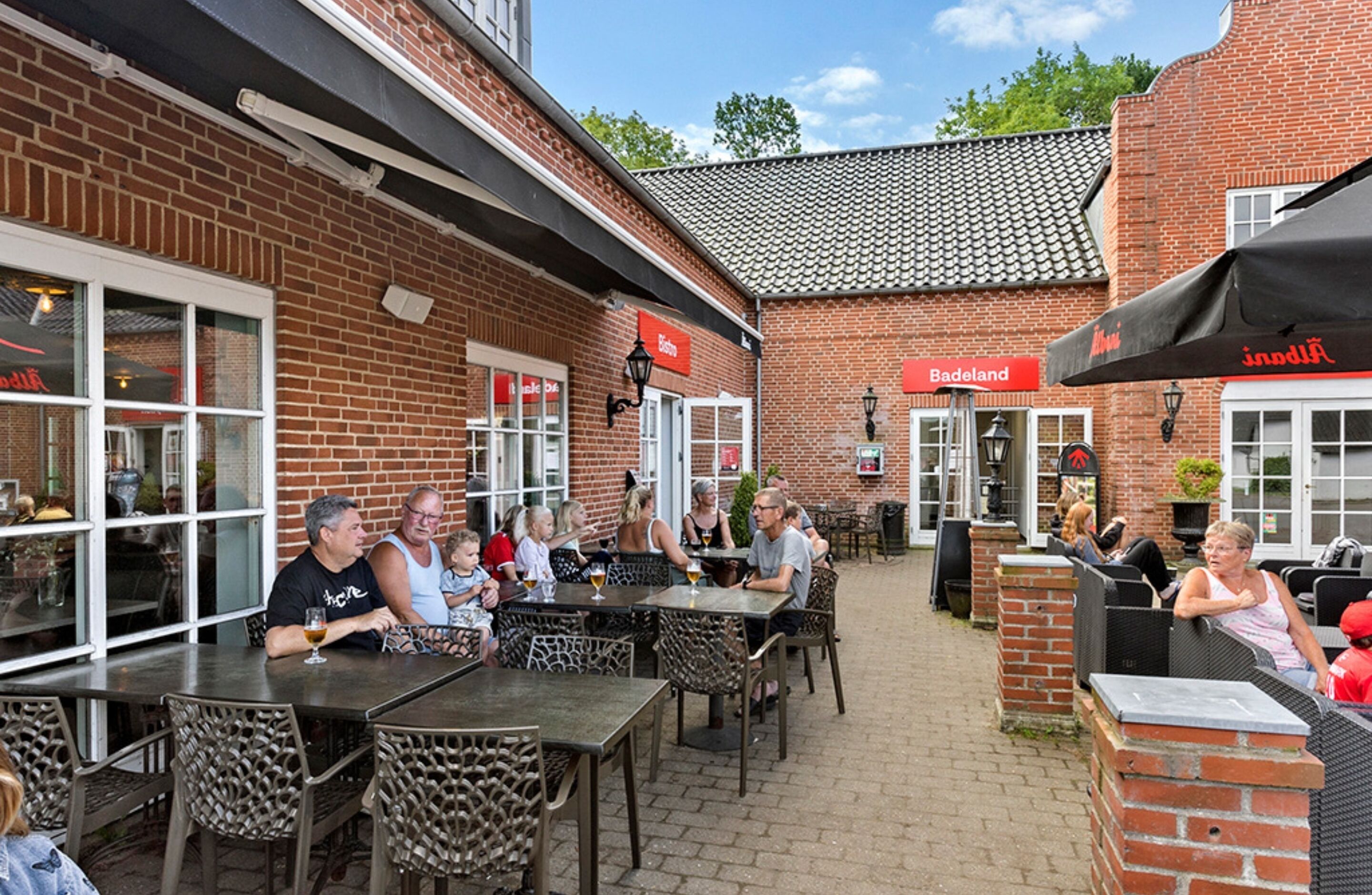 An outdoor patio area with brick walls, outdoor seating, and tables.