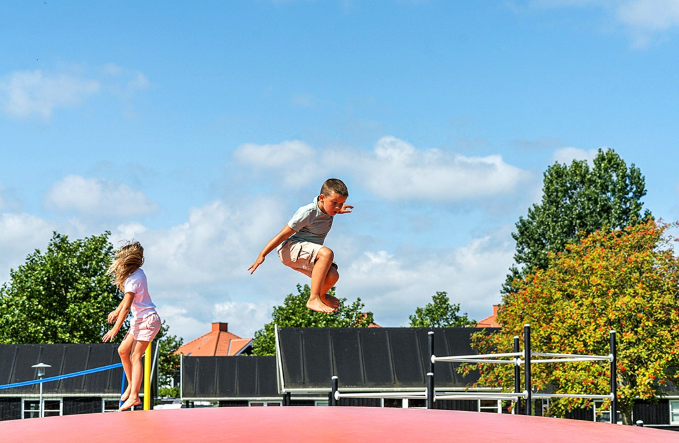 A trampoline with two children jumping.