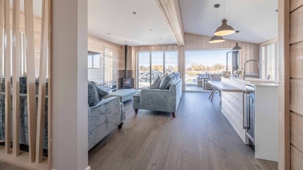 A modern interior with a kitchen, dining area, and seating space.