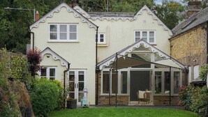 A two-story house with a conservatory, a lawn, and a garden. - 4 Bed Family Home In Windsor - By Tempstay (Old Windsor)